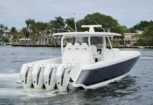 Slide: The Image of 2023 Intrepid 475 Panacea boat with four outboard engines cruising on water. - 3