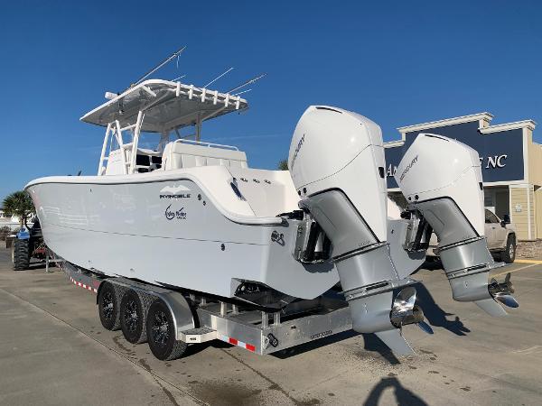 Slide: The Image of 2024 Invincible 33 Catamaran with twin outboard engines on a trailer. - 1