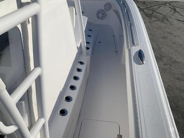 Slide: The Image of 2024 Invincible 33 Catamaran deck with rod holders and storage compartments. - 14
