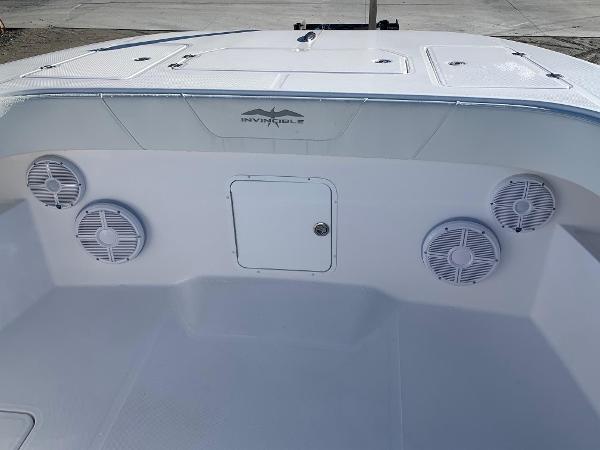 Slide: The Image of 2024 Invincible 33 Catamaran boat interior with speakers and storage compartment. - 16