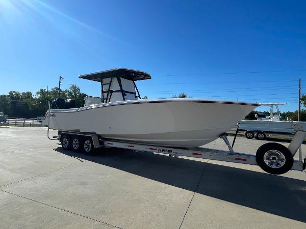 Slide: The Image of 2024 Invincible 33 Open Fisherman boat on a trailer in a parking lot. - 5