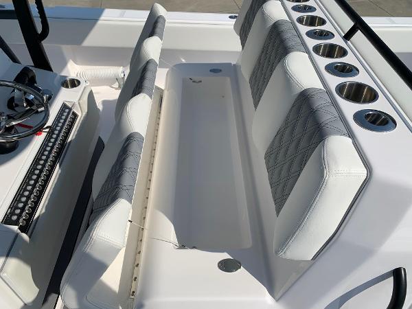 Slide: The Image of 2024 Invincible 35 Catamaran interior seating with cup holders and storage compartment. - 14