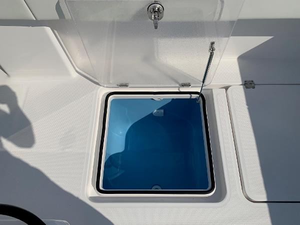 Slide: The Image of Open hatch on 2024 Invincible 35 Catamaran showing storage compartment. - 7