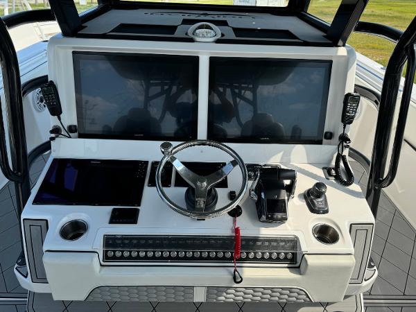 Slide: The Image of Control panel of 2024 Invincible 40 Catamaran with dual screens and steering wheel. - 18