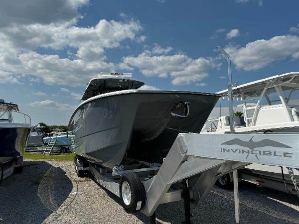 Slide: The Image of 2024 Invincible 40 Catamaran on trailer under blue sky. - 2