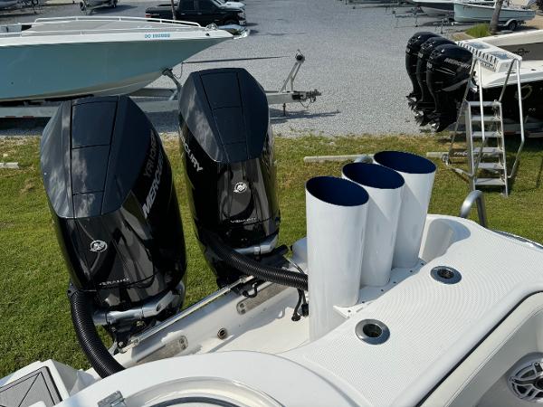 Slide: The Image of 2024 Invincible 40 Catamaran with dual Mercury outboard engines at a marina. - 27