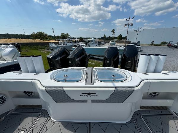 Slide: The Image of 2024 Invincible 40 Catamaran with powerful Mercury engines, sleek design, and spacious deck. - 28