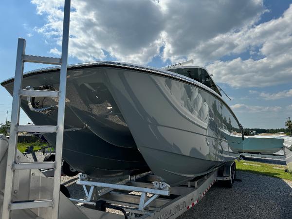 Slide: The Image of 2024 Invincible 40 Catamaran on trailer under cloudy sky. - 3