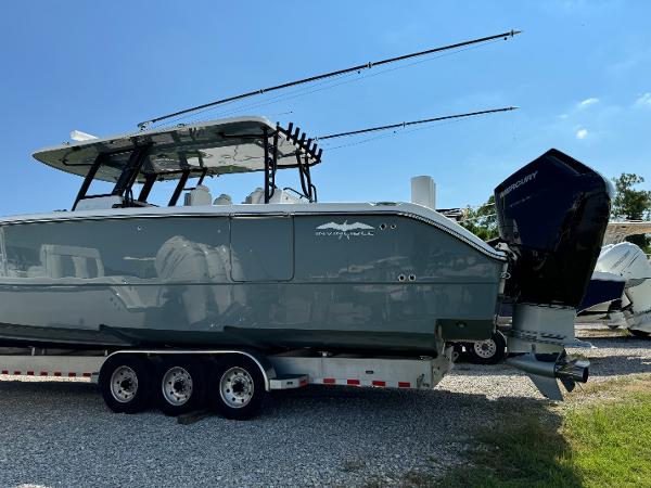 Slide: The Image of 2024 Invincible 40 Catamaran on trailer, sleek design, powerful outboard engines. - 4