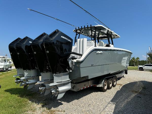 Slide: The Image of 2024 Invincible 40 Catamaran with four Mercury outboard engines on a trailer. - 8