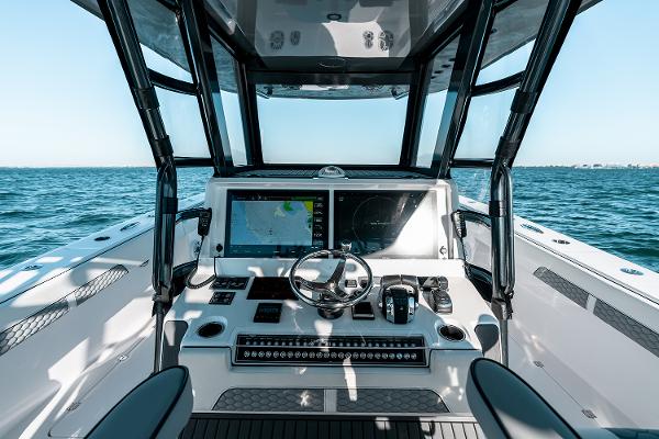 Slide: The Image of Helm of 2026 Invincible 46 Catamaran with advanced navigation system on open water. - 7