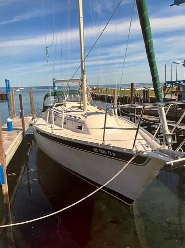 Slide: The Image of 1983 Irwin Citation 34 sailboat docked at a marina. - 2