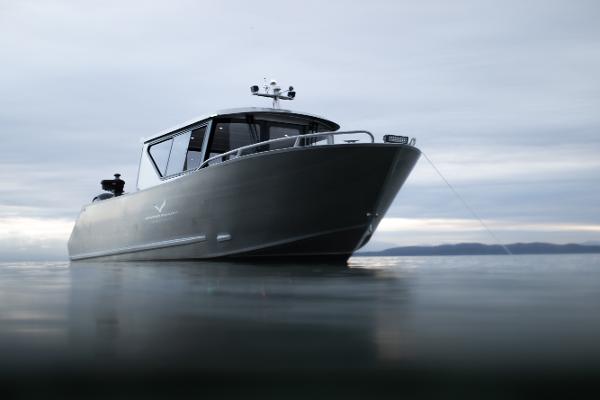 Slide: The Image of 2025 Jasper Marine Defender 22 boat on calm water. - 0