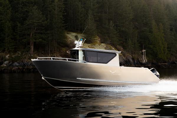 Slide: The Image of 2025 Jasper Marine Defender 22 boat cruising on a forest-lined lake. - 12
