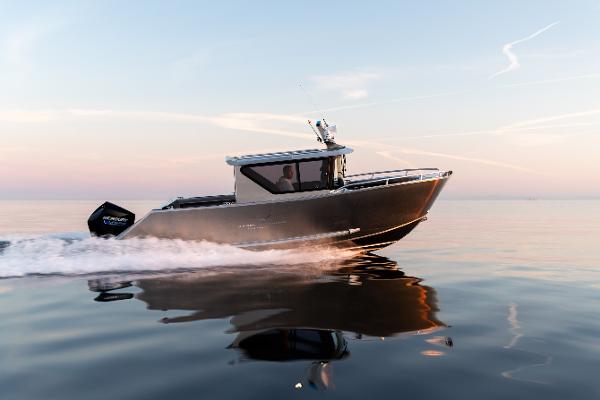 Slide: The Image of 2025 Jasper Marine Defender 22 boat cruising on calm water at sunset. - 13