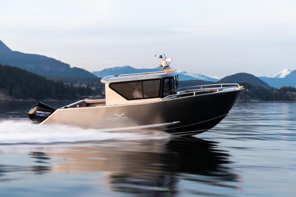 Slide: The Image of 2025 Jasper Marine Defender 22 boat cruising on a serene lake with mountainous background. - 15
