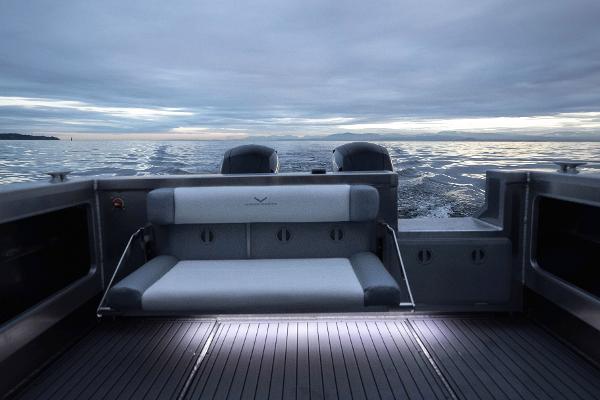 Slide: The Image of Jasper Marine Defender 22 (2025) boat interior with ocean view at dusk. - 24