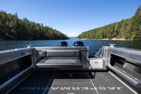 Slide: The Image of Jasper Marine Defender 22 boat on a serene lake surrounded by lush forests, 2025 model. - 26
