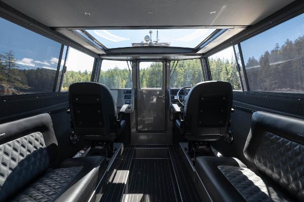 Slide: The Image of Interior of 2025 Jasper Marine Defender 22 boat with panoramic windows and luxurious seating. - 32