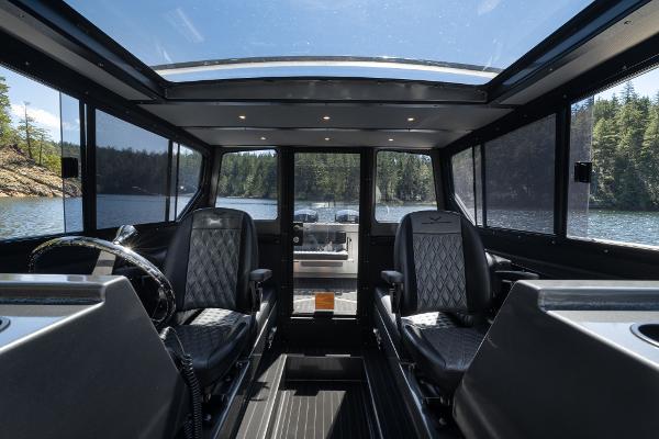 Slide: The Image of Interior of 2025 Jasper Marine Defender 22 boat with panoramic windows and luxury seating. - 33