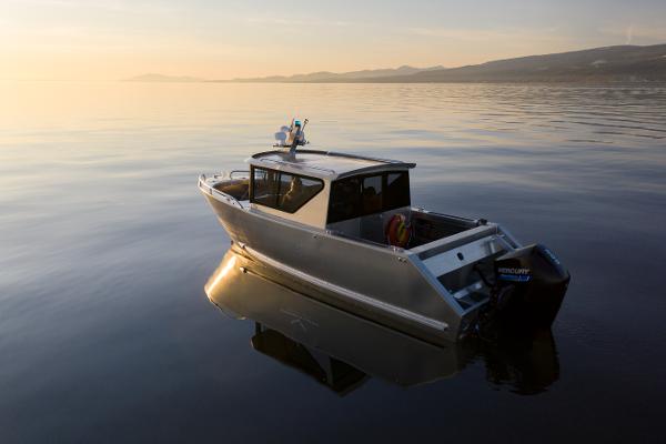 Slide: The Image of 2025 Jasper Marine Defender 22 boat on calm water at sunset. - 6