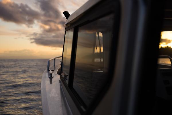 Slide: The Image of Jasper Marine Defender 22 boat at sunset on the ocean, 2025 model. - 7