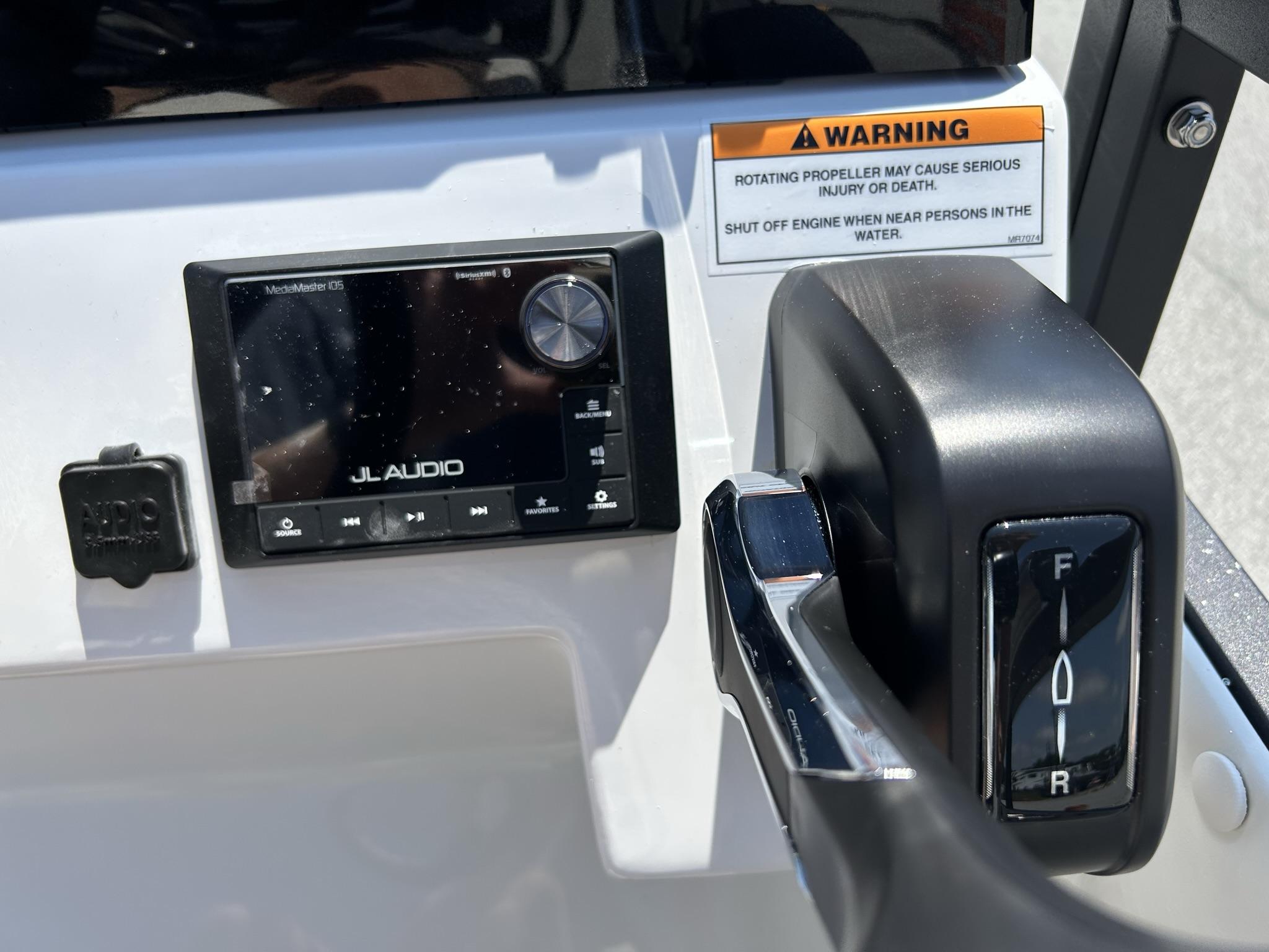 Slide: The Image of Control panel of 2024 JC 247 TT boat with JL Audio system and throttle lever. - 16
