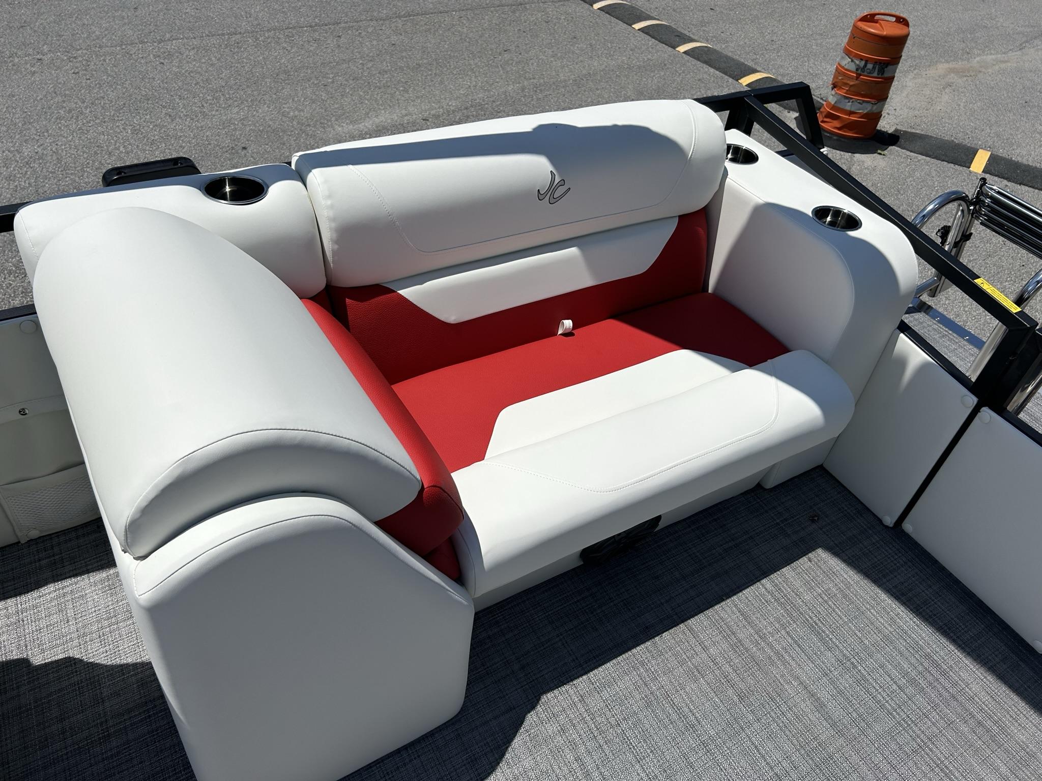 Slide: The Image of 2024 JC 247 TT boat interior with white and red seating, cup holders, and logo. - 21