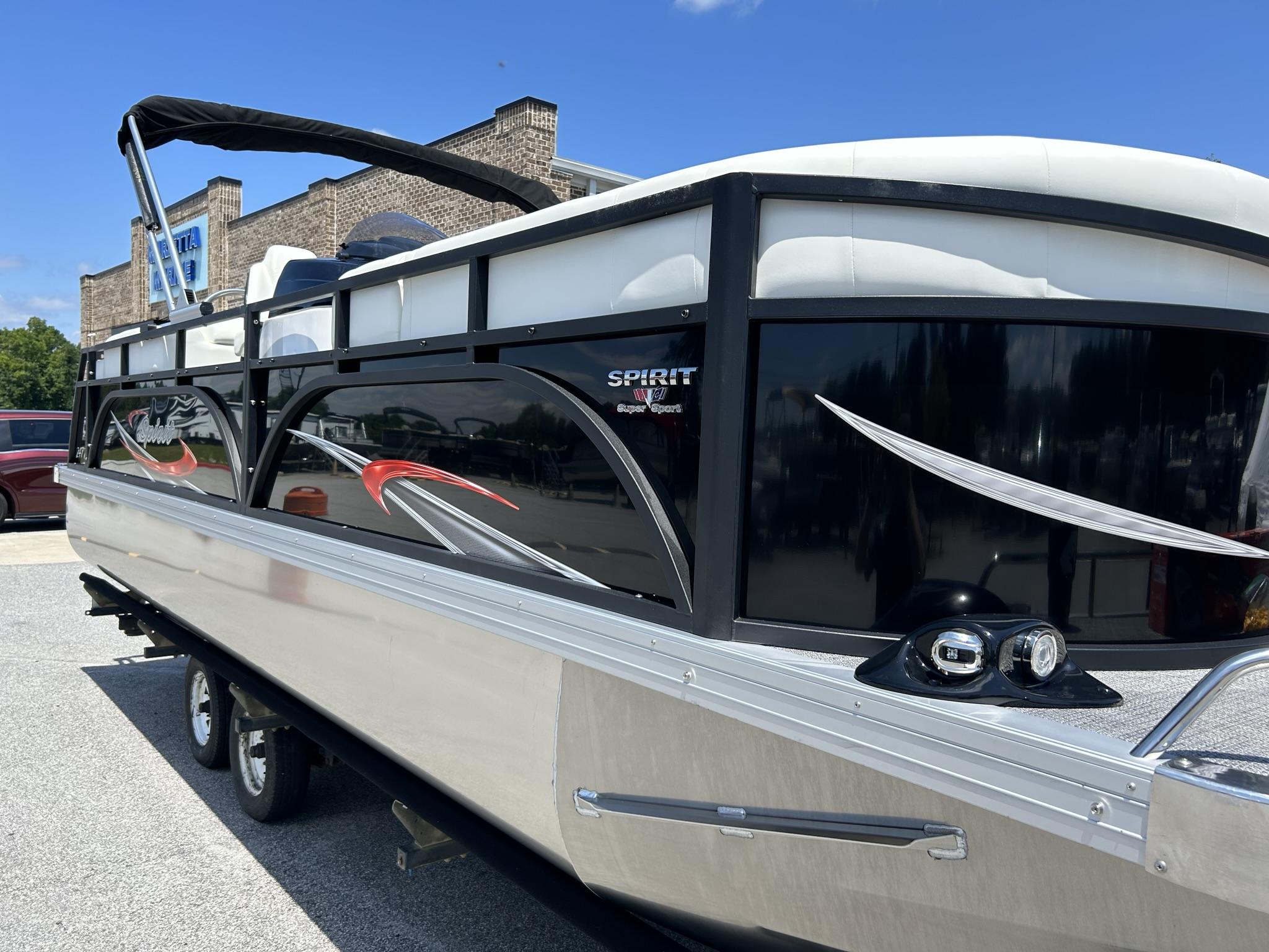 Slide: The Image of 2024 JC 247 TT DSL Sport pontoon boat with Suzuki 250HP engine, parked outdoors. - 24