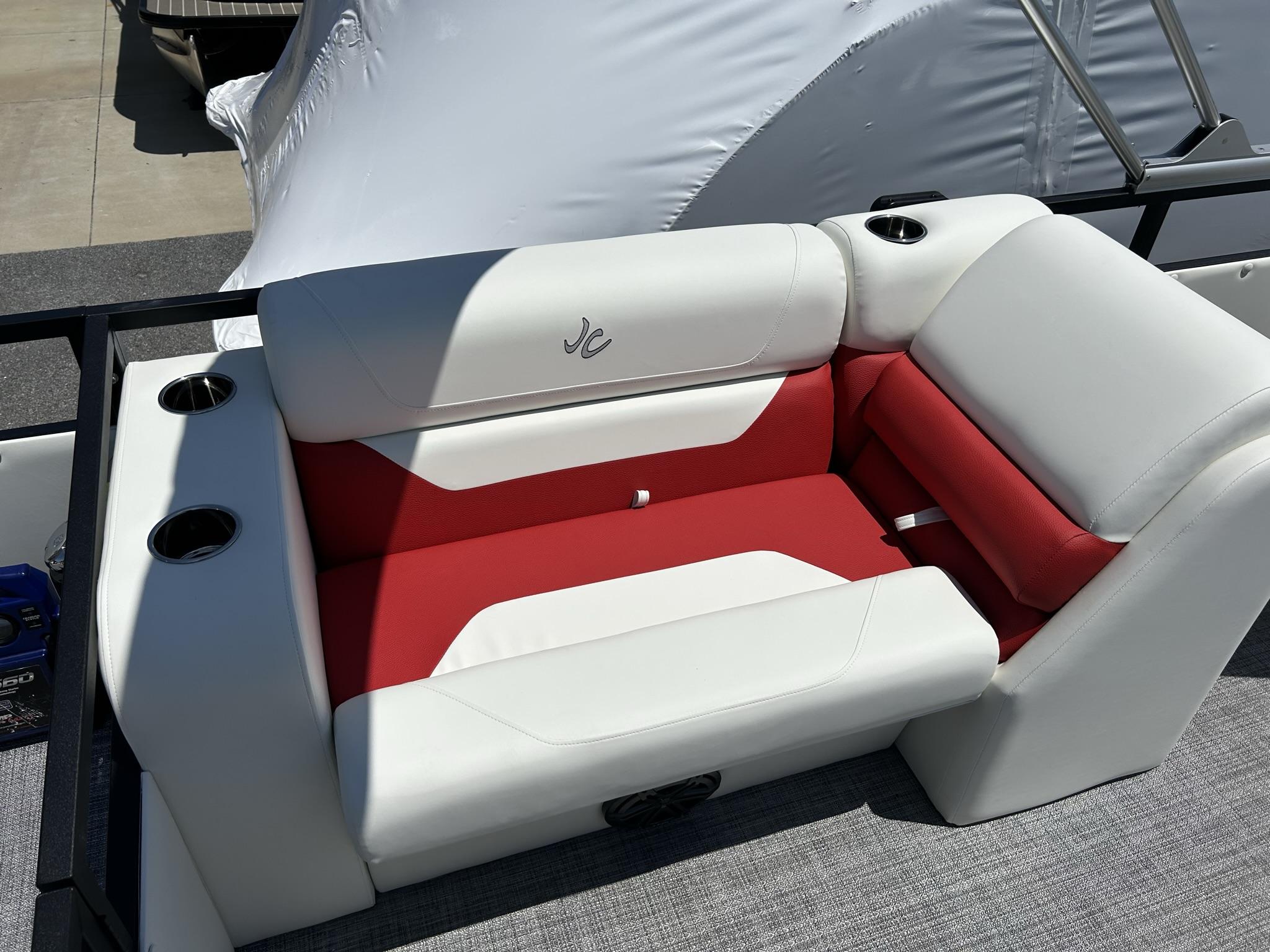 Slide: The Image of Luxurious seating on 2024 JC 247 TT boat, featuring red and white upholstery with cup holders. - 7