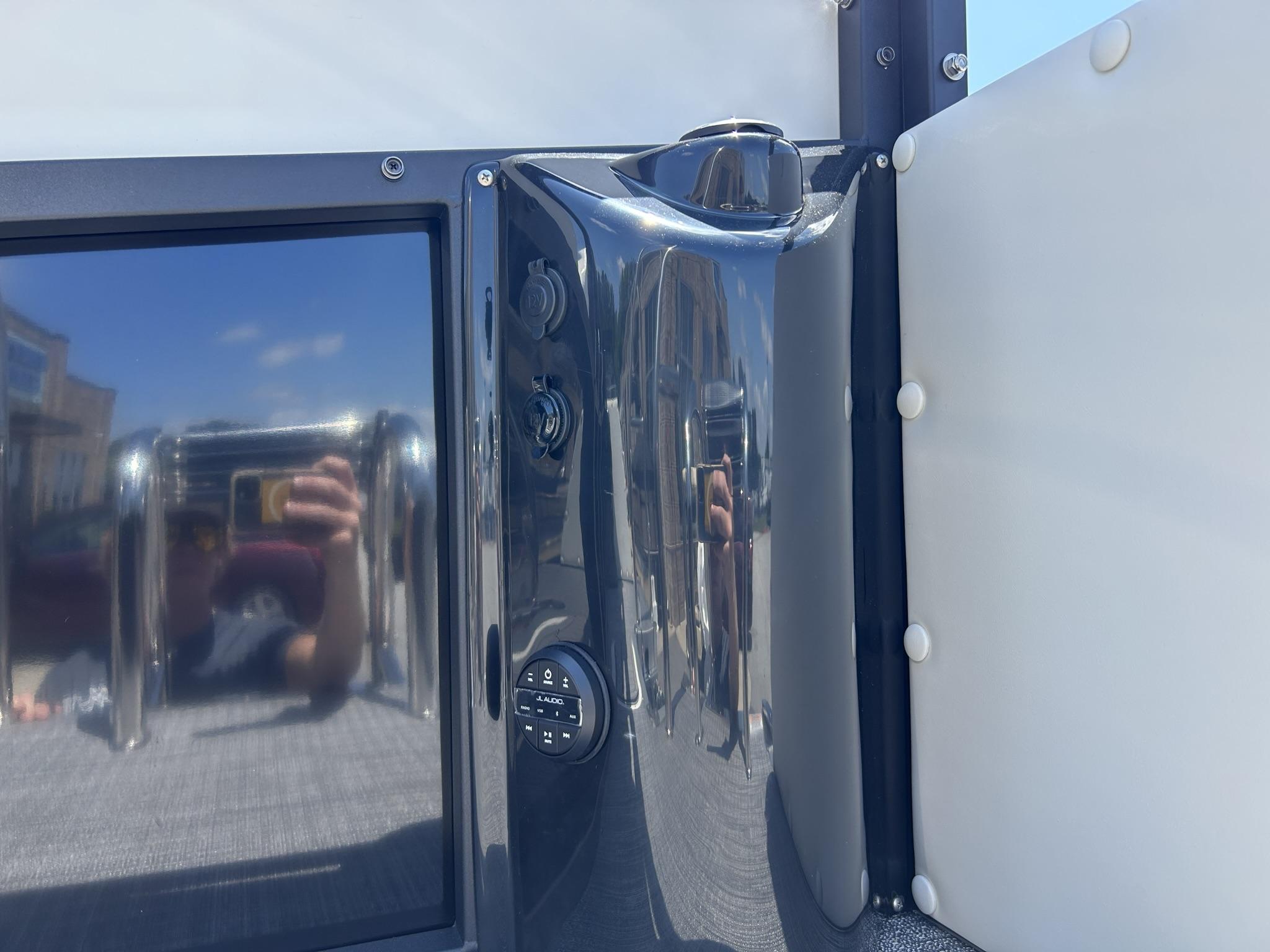 Slide: The Image of 2024 JC 247 TT boat dashboard with controls and reflection. - 8