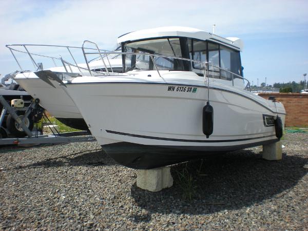 Slide: The Image of 2019 Jeanneau 695 boat on dry dock, white hull, side view. - 1