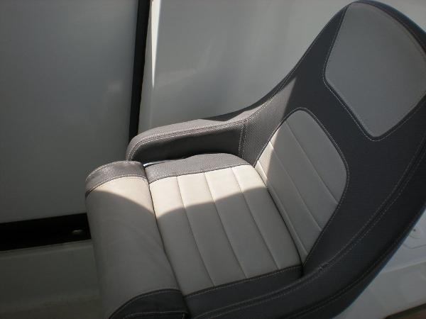 Slide: The Image of Comfortable seating in 2019 Jeanneau 695 boat, featuring sleek gray upholstery. - 10