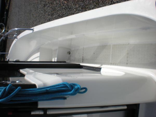 Slide: The Image of 2019 Jeanneau 695 boat deck with blue rope and railing. - 2