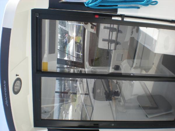 Slide: The Image of 2019 Jeanneau 695 boat interior with sliding glass door and blue rope. - 6