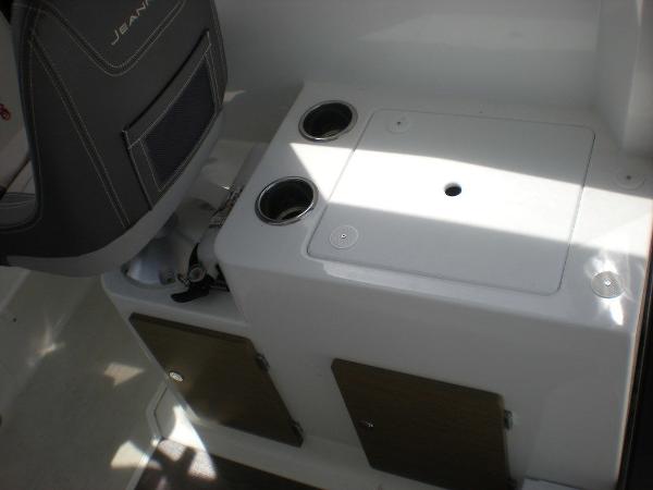 Slide: The Image of 2019 Jeanneau 695 boat interior with storage compartments and cup holders. - 8
