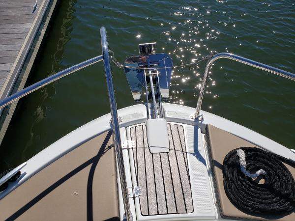 Slide: The Image of Bow of 2016 Jeanneau Merry Fisher 855 at dock, showing anchor and deck. - 14
