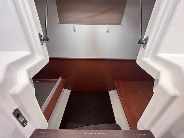Slide: The Image of 2016 Jeanneau Merry Fisher 855 cabin interior with wooden accents and white walls. - 23