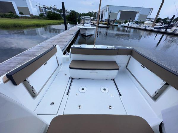 Slide: The Image of 2016 Jeanneau Merry Fisher 855 boat docked at marina, spacious seating area. - 4