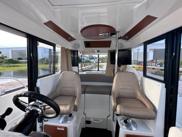 Slide: The Image of Interior of 2016 Jeanneau Merry Fisher 855 boat with dual captain chairs. - 8