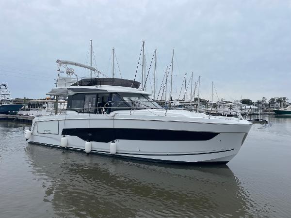 Slide: The Image of 2024 Jeanneau NC 1295 FLY yacht docked in a marina. - 25
