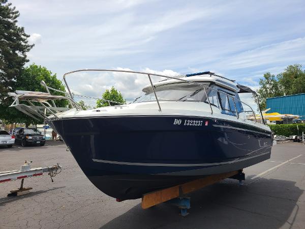 Slide: The Image of 2021 Jeanneau NC 795 S2 boat on trailer in parking lot. - 1