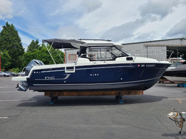 Slide: The Image of 2021 Jeanneau NC 795 S2 boat on a trailer in a parking lot. - 4