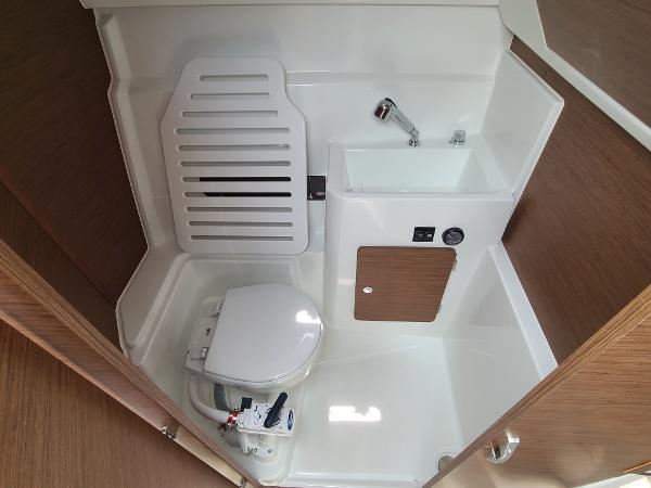 Slide: The Image of 2021 Jeanneau NC 795 S2 boat bathroom with toilet and sink. - 7