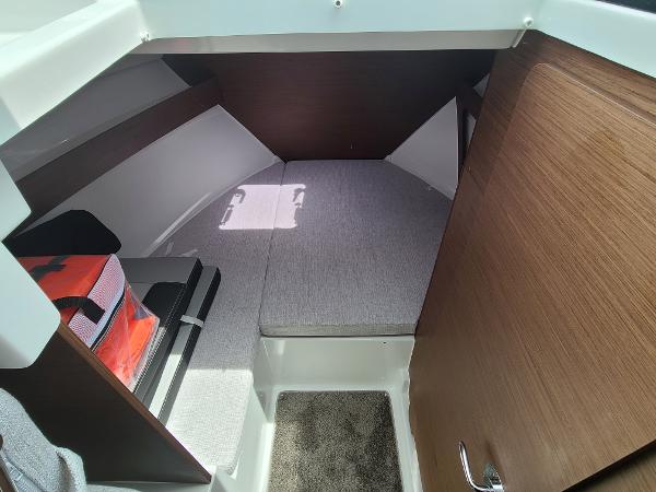 Slide: The Image of 2021 Jeanneau NC 795 S2 cabin interior with bed and storage space. - 8