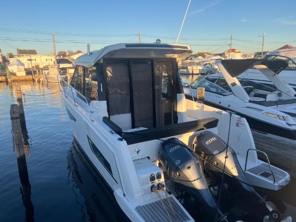Slide: The Image of 2020 Jeanneau NC 895 boat docked with twin Yamaha outboard engines. - 1