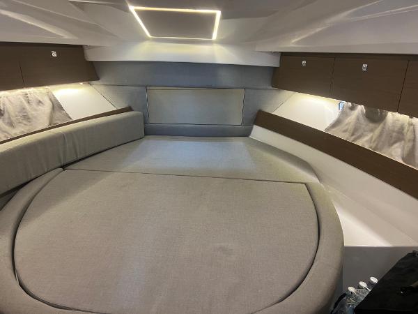 Slide: The Image of 2020 Jeanneau NC 895 cabin interior with modern lighting and comfortable seating. - 14