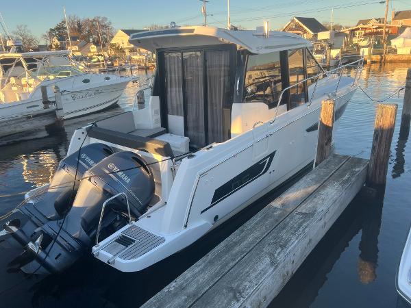 Slide: The Image of 2020 Jeanneau NC 895 boat docked with Yamaha outboard motor. - 2