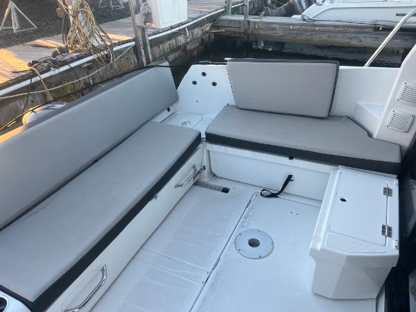 Slide: The Image of 2020 Jeanneau NC 895 boat interior with gray seating and storage compartments. - 3