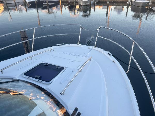 Slide: The Image of 2020 Jeanneau NC 895 boat deck with railing, docked in calm marina waters. - 4